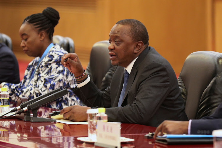 President Uhuru Kenyatta talks with with Chinese President Xi Jinping during the meeting at the Great Hall of People in Beijing on April 25