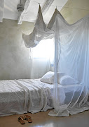 A casually draped fabric canopy above the bed gives this bedroom a dreamy feel.


