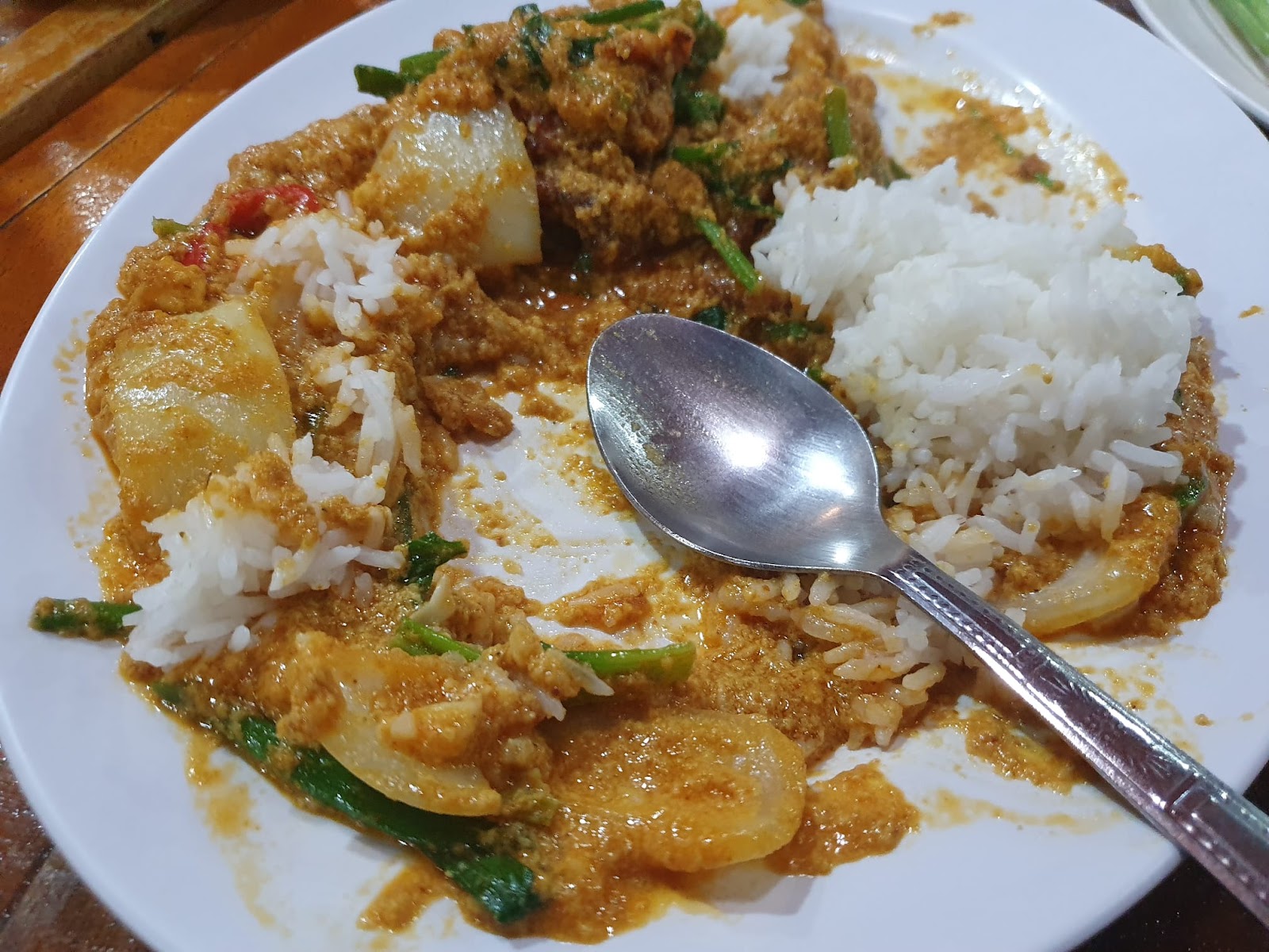 half eaten soft shell crab yellow curry with rice from Northeast Restaurant in Bangkok