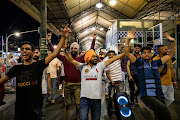 Revellers celebrate the new year in front of Flinders Street Station during New Year's Eve celebrations on January 1 2022 in Melbourne, Australia.