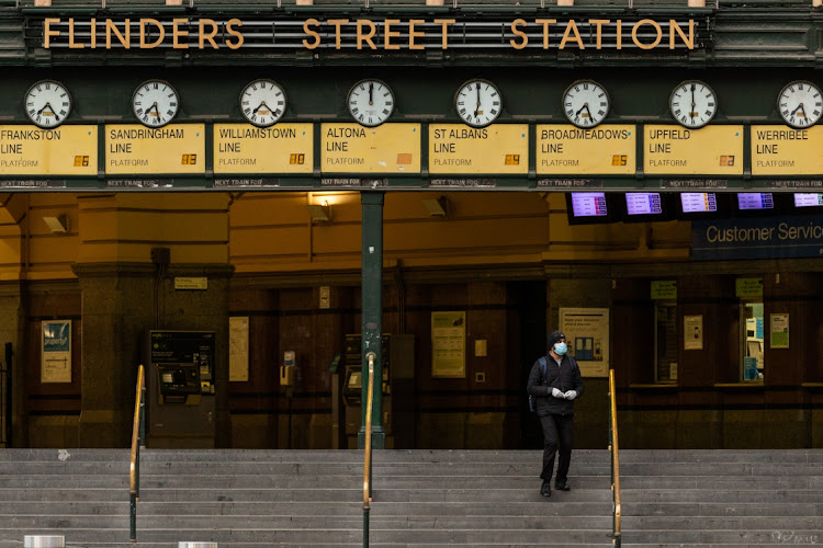 A lone commuter walks out of Flinders Street station on August 6 2020 in Melbourne, Australia. Picture: GETTY IMAGES/ASANKA RATNAYAKE