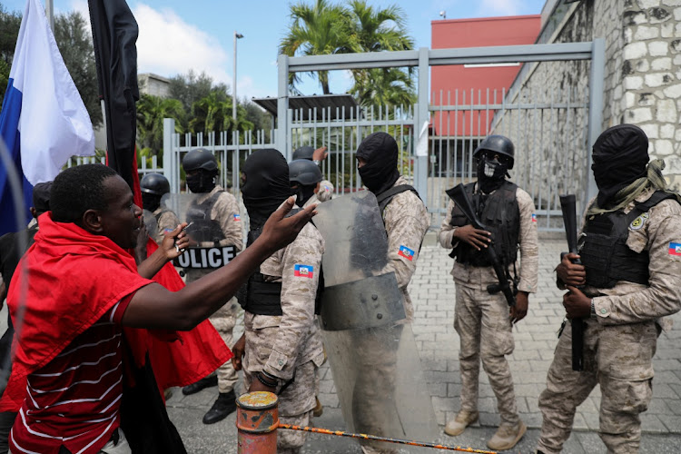 A demonstrator argues with police officers as he takes part in a protest calling for the resignation of Haitian Prime Minister Ariel Henry outside the Canadian Embassy, in Port-au-Prince, Haiti February 25 2024.