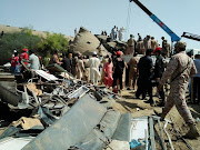 Paramilitary soldiers and rescue workers gather at the site following a collision between two trains in Ghotki, Pakistan June 7, 2021. 