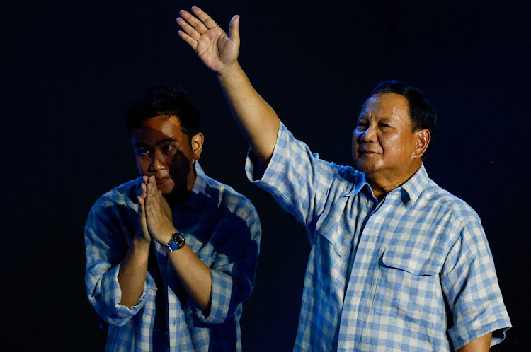 Presidential candidate Prabowo Subianto gestures to his supporters next to Vice President candidate Gibran Rakabuming Raka as Subianto claims victory after unofficial vote counts during an event to watch the results of the general election in Jakarta, Indonesia on February 14 2024. Picture: REUTERS/Kim Kyung-Hoon