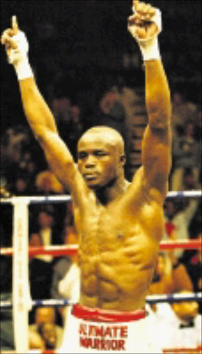 BACK TO WEMBLEY: IBF welterweight champion Isaac 'The Angel' Hlatshwayo. Pic. Raymond Preston. 22/05/2004. © Sowetan. isaac hlatshwayo at canival city on 22/5/2004 pic by raymond preston