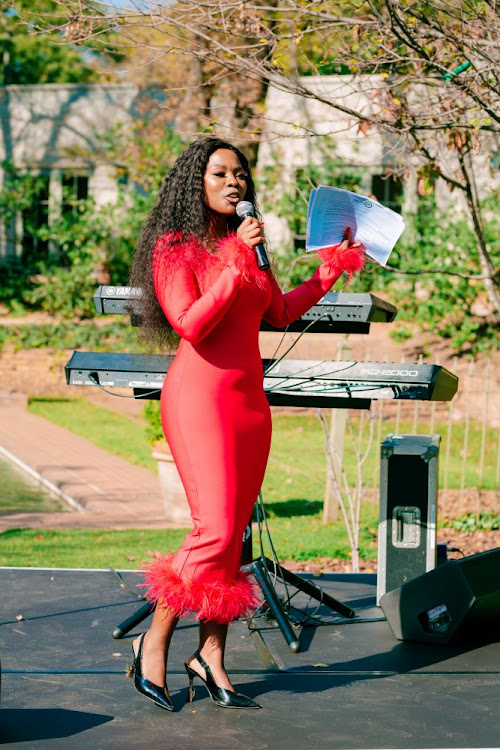 Host Nambitha Ben-Mazwi speaking to guests at the Bombay event in Hyde Park, Johannesburg.