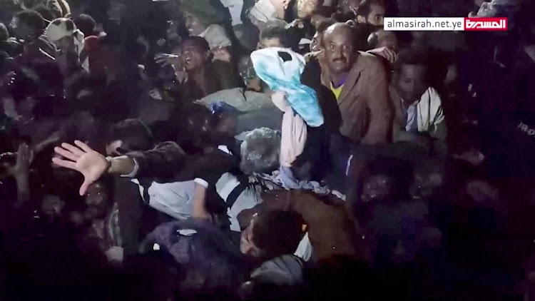 People trapped in the crowd attempt to free themselves during a stampede in Sanaa, Yemen, April 19, 2023, in this still image taken from video.