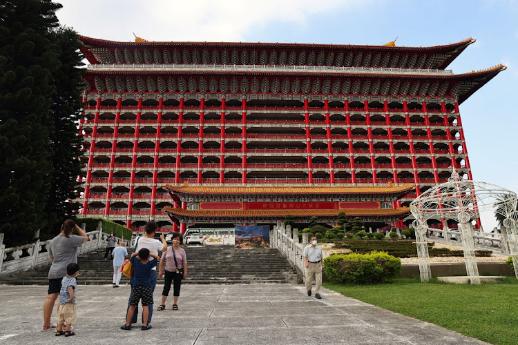 Tourists pose for photos outside the Grand Hotel, whose underground spaces will be used as air-raid shelters in the event of an attack, in Taipei, Taiwan July 21 2022. Picture: REUTERS/ANN WANG