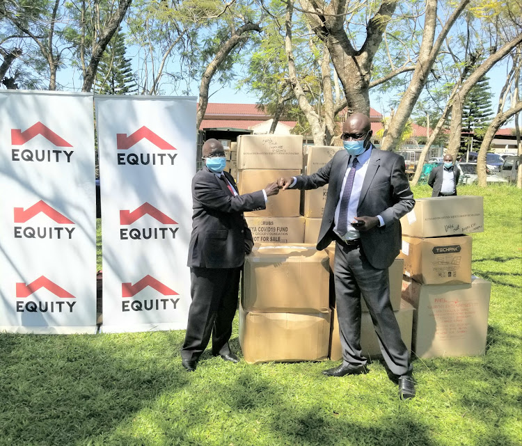 Equity Bank director Sam Onyango presents PPE to Siaya Governor Cornel Rasanga