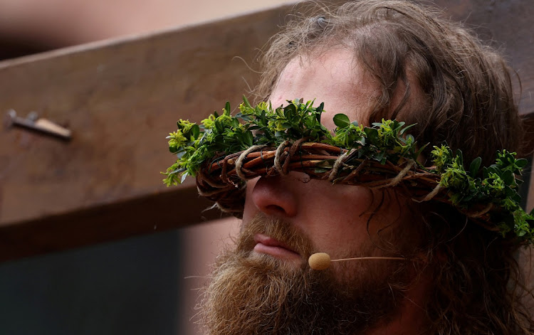 A man takes part in a re-enactment of the crucifixion of Jesus Christ on Good Friday in Bensheim, Germany, March 29 2024. Picture: REUTERS/Kai Pfaffenbach