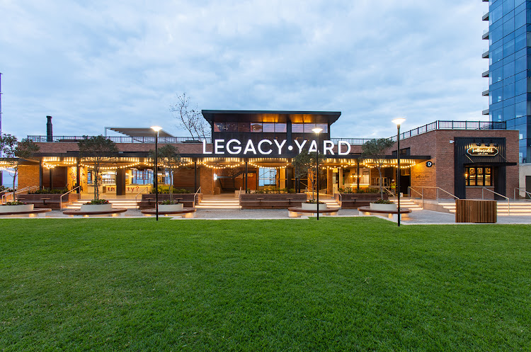 The restaurants of Legacy Yard at Umhlanga Arch are arranged around an open lawn.