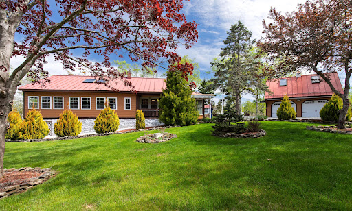 Brown house, red roof, green garden in this luxury house for sale in Bristol ($918,000)