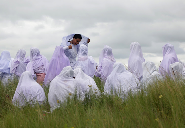 A maiden reacts after receveing blessings from Ekuphakameni Nazareth Baptist Church on Nhlangakazi mountain. Photo: SANDILE NDLOVU