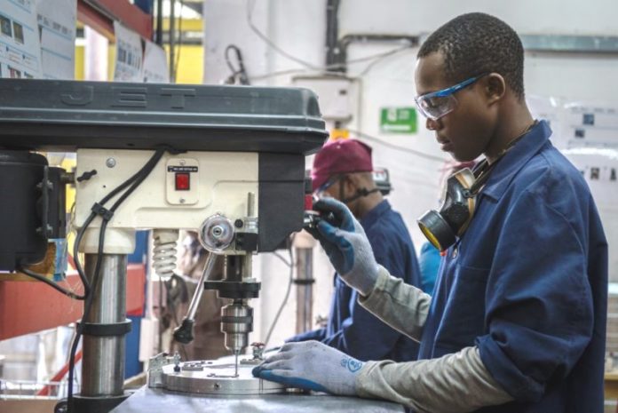 This is a young black young man who is skilled as a manufacturer, in this picture he is on duty. 