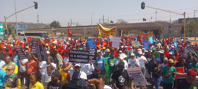 More than 1,000 supporters of opposition parties and civil society groups clad in EFF, UDM, ATM, ACDP and Cope colours march to the public protector's office on Friday to demand the release of a report on a probe into the Phala Phala heist..