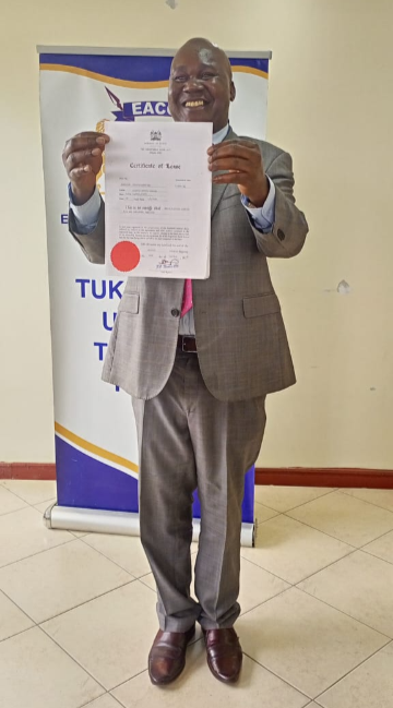 Ignatius Wekesa, Regional Manager for EACC South Rift Regional Office in Nakuru receiving a surrendered Title Deed on behalf of the Commission.