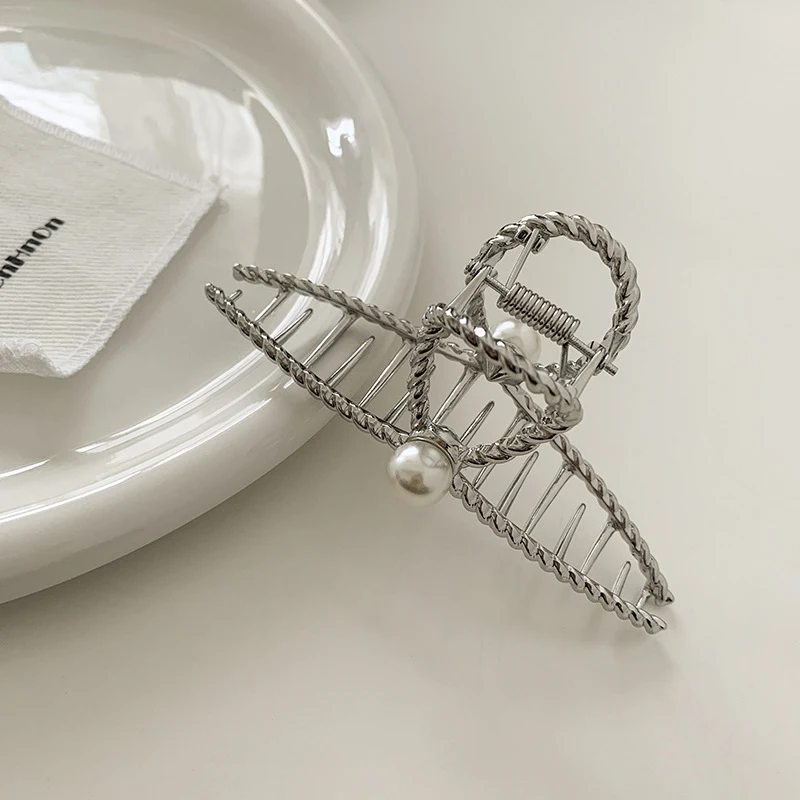 Fermaglio per capelli in metallo con perla a croce intrecciata Accessorio moda. Elegante e raffinato per creare acconciature uniche e alla moda con fissaggio sicuro.