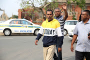 Sagren Govindsamy (in the yellow and blue sweater) is the father and husband of the three women who were killed in Phoenix last Friday outside the Verulam Magistrate's court on Tuesday.