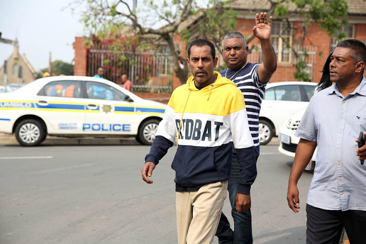 Sagren Govindsamy (in the yellow and blue sweater) is the father and husband of the three women who were killed in Phoenix last Friday outside the Verulam Magistrate's court on Tuesday.