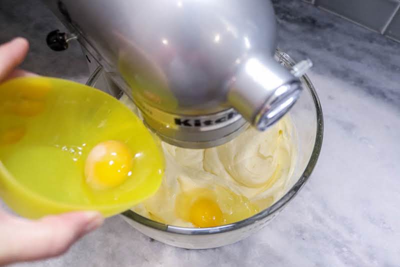 Adding Egg To Butter, Cream Cheese, And Sugar.