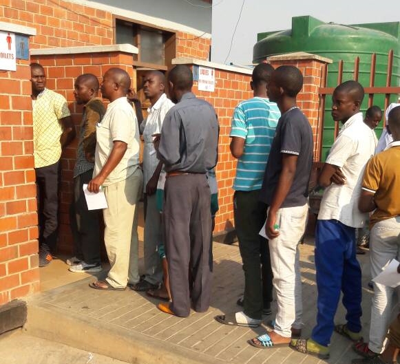 Travellers queue at the Zimbabwe-Zambia border post for poo tests amid an ongoing cholera outbreak on 27 September 2018.