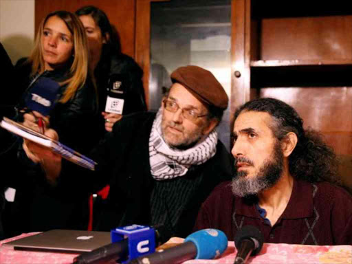 Former Guantanamo detainee Jihad Diyab (r) from Syria answers media questions during a news conference, while on a hunger strike, in Montevideo, Uruguay, September 30, 2016. /REUTERS