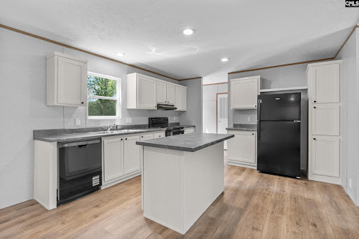 Modern kitchen with central island and black appliances - House purchase in Kershaw, 3 bedrooms