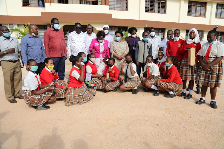 Parliamentary committee on Education and Research led by Chairperson Florence Mwikali Mutua with Kilifi North MP Owen Baya take photos with students of St thomas girlssecondary school after a meeting to discuss the cause of mass failures in KCSE in the county