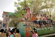 Here in the Muslim area of Juhapura, Ahmedabad, a film crew of two women document chronic water problems. The truck they are standing on visits sporadically, providing families with two buckets of water every 24 hours.