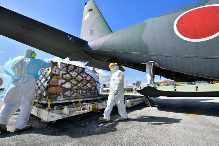 Relief supplies are unloaded from Japan Self-Defense Forces' C-130 Hercules after the airplane arrived at Fua'amotu International Airport on the island of Tongatapu, Tonga on January 22 2022. Picture: JAPAN DEFENSE MINISTRY via REUTERS