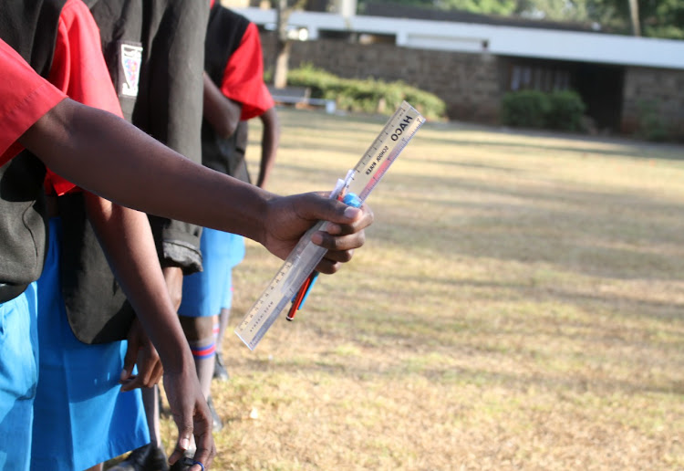 Candidates line up for frisking during start of KCSE at Starehe Boys Center, Nairobi, on March 14, 2022.