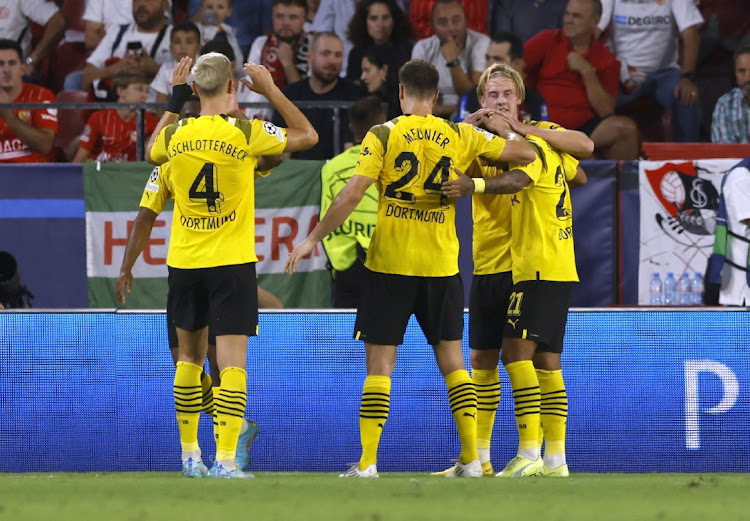 Borussia Dortmund's Julian Brandt celebrates scoring their fourth goal with teammates during their maych against Sevilla in Seville, Spain, on October 5 2022. Picture: REUTERS/MARCELO DEL POZO