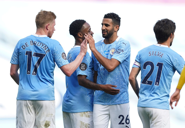 Manchester City's Riyad Mahrez celebrates scoring their fourth goal with teammates, as play resumes