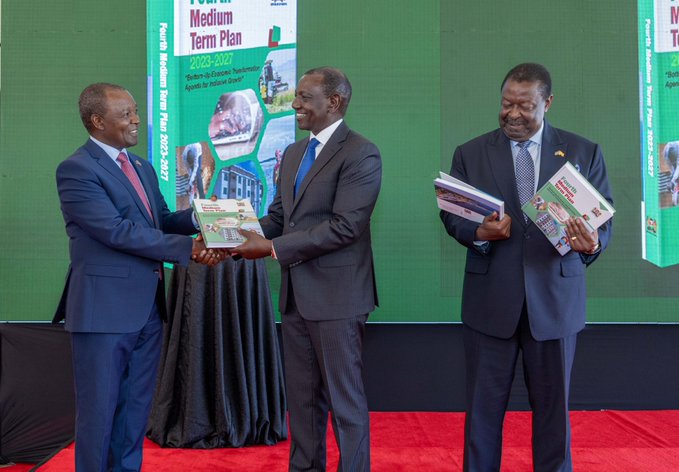 President William Ruto receives a copy of the country's Medium Term Plan from National Treasury Cabinet Secretary Njuguna Ndung'u on March 21, 2024.