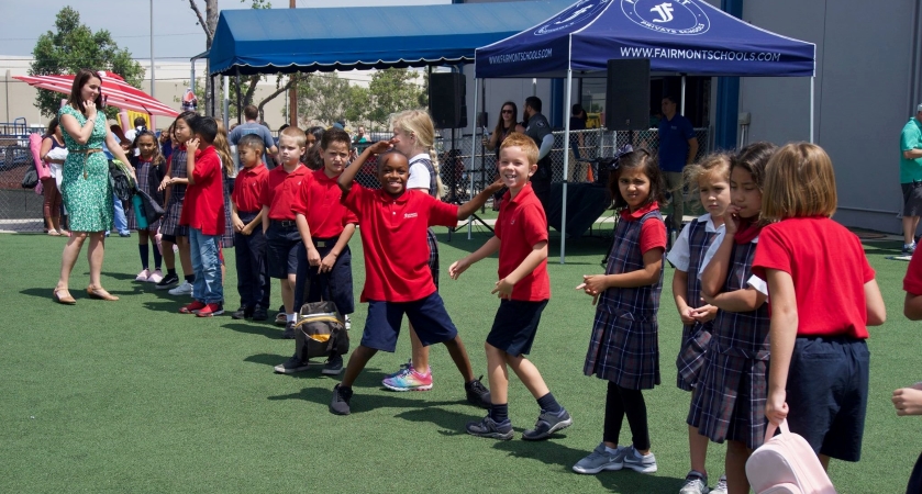 Children, dressed in their red and navy school uniforms, are lined up during an outside event for Fairmont Schools in Anaheim, CA