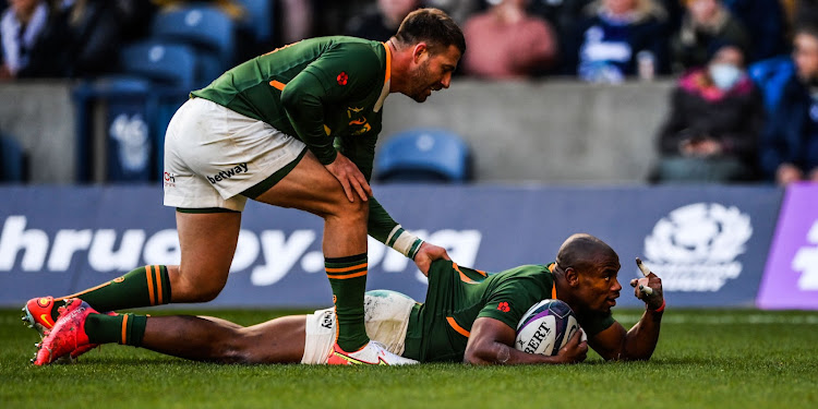 Makazole Mapimpi celebrates with Willie le Roux after scoring one of his two tries.