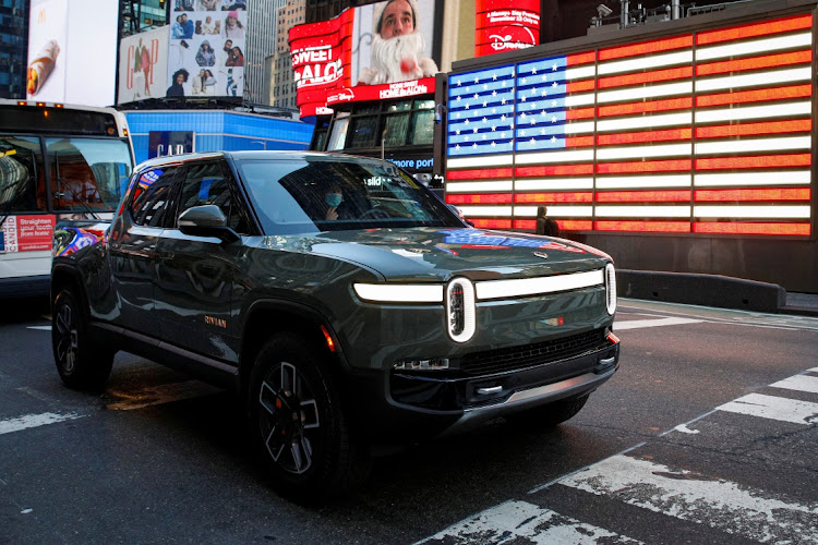 A Rivian R1T pickup, the Amazon-backed electric vehicle (EV) maker, is driven through Times Square during the company’s IPO in New York, the US, November 10 2021. Picture: BRENDAN MCDERMID/REUTERS