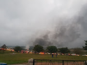 Columns of smoke rise from burning trucks on the N3 highway at the Mooi River Toll, where rioters ran rampant on Monday.