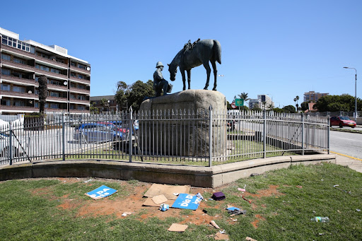 On the inside of the fenced area that surround the Horse Memorial it is clean, but litter lies strewn on the outside.