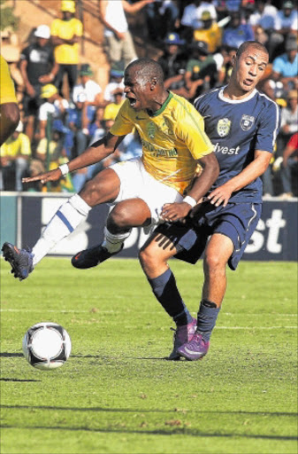 TWO-GOAL HERO: Mamelodi Sundowns striker Nyasha Mushekwi, left, is fouled by Bidvest Wits' Miquel Timm during their Nedbank Cup match at Milpark Stadium in Johannesburg yesterday. PHOTO :VELI NHLAPO