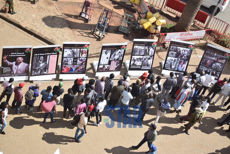 Members of the public converge at the Kenya National Archives to view portraits mounted of the late President Mwai Kibaki a day ahead of his burial. April 29, 2022/ CHARLENE MALWA