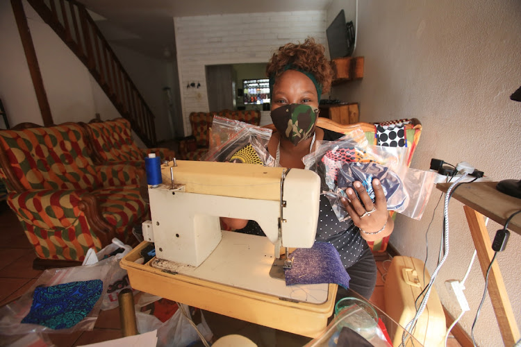 Amalinda seamstress Cebisa Gobe holds some of her creative, bright coloured cloth face masks. Covid-19 has seen a surge in the cloth face mask business with South Africans required to wear them in public.