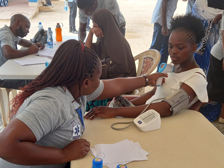 A nurse checks a patient's temperature during free cancer screening at Kinondo Kwetu Hospital in Kwale county on Tuesday, February 20, 2024.