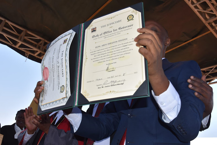 Isiolo Governor Abdi Hassan Guyo showing his certificate during the swearing in ceremony at the Isiolo Boys High School on August 25,2022.