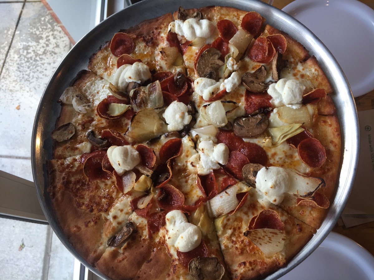 White gluten free pizza with pepperoni, mushrooms, onions, and artichokes. So good.