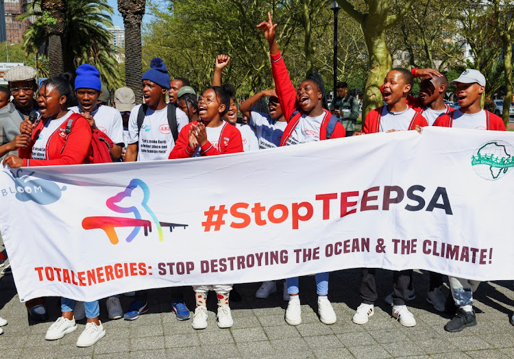 Climate activists hold a banner as they call for climate justice resistance against oil and gas corporations and to end fossil fuels outside the Cape Town International Convention Centre during the Southern Africa Oil and Gas Conference in Cape Town, South Africa , September 13, 2023.