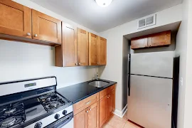 Kitchen with tile flooring, stainless steel appliances, and wood cabinets