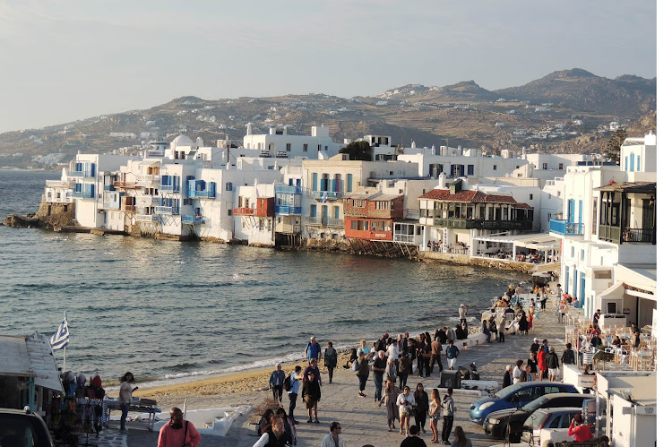 Cruise ship passengers begin the explore the waterfront of Mykonos. 