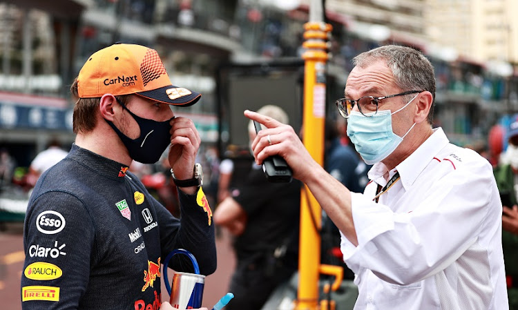 Second place qualifier Max Verstappen of Netherlands and Red Bull Racing talks with Stefano Domenicali, CEO of the Formula One Group, in parc ferme during qualifying for the F1 Grand Prix of Monaco at Circuit de Monaco on May 22, 2021 in Monte-Carlo, Monaco.