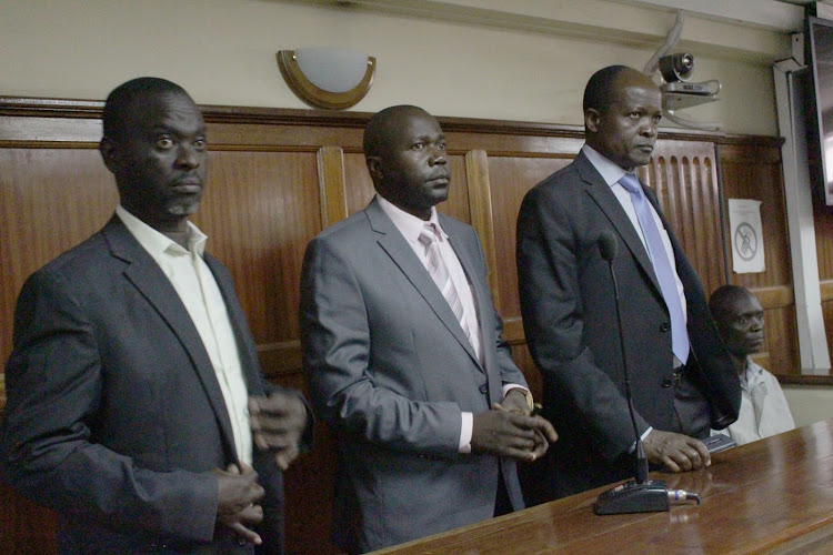 Migori Governor Okoth Obado his co-accused Caspal Obiero (left) and Michael Oyamo at a Milimani court on May 7, 2019.